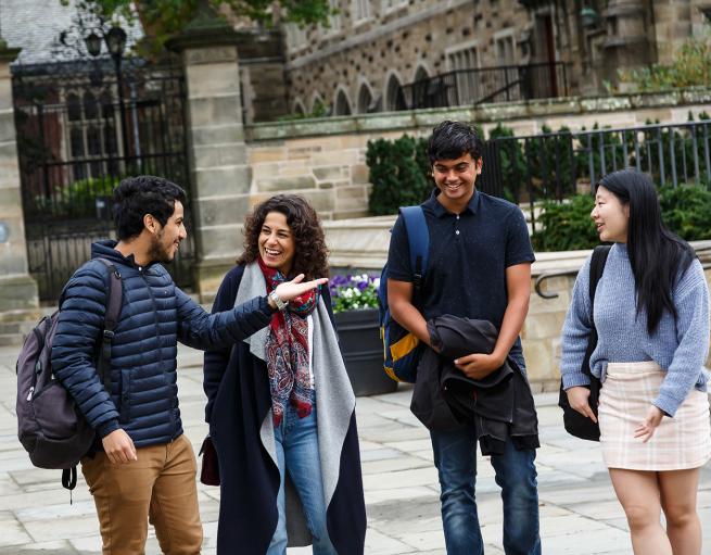 Students walk and talk together on campus