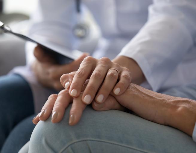 Closeup of a doctor holding a patient's hand