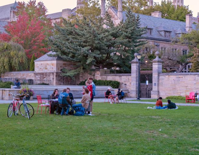 Students sitting outside on Cross Campus