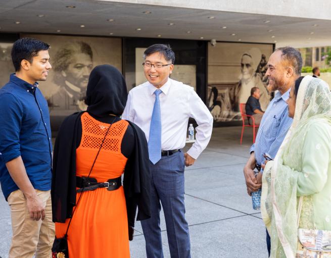 Marvin Chun talks with students and families during commencement festivities in 2022