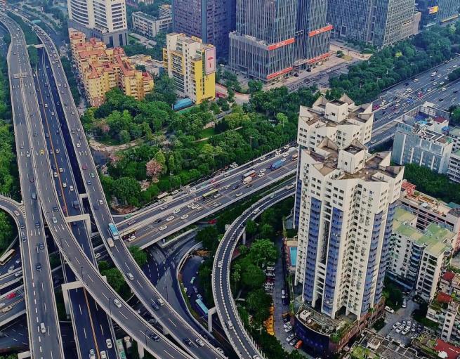 Aerial view of a highway interchange in a densely populated urban area