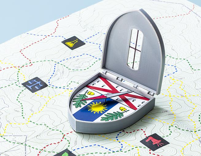 Compass with Yale School of the Environment crest on it sitting on a map