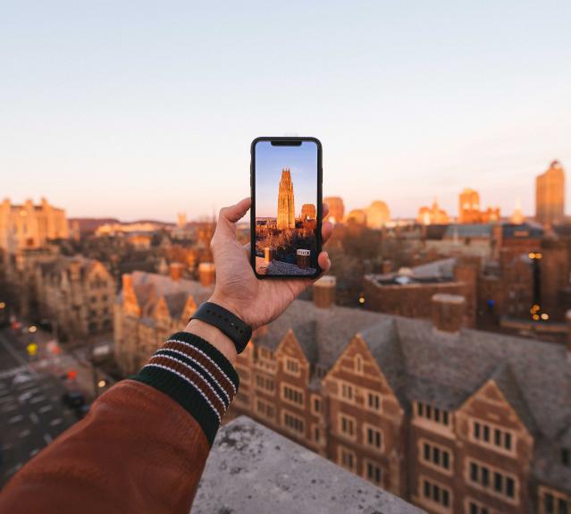 Student taking a photo of Yale campus