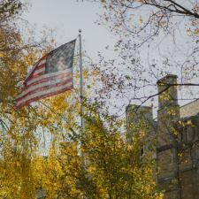 An American flag waves on campus