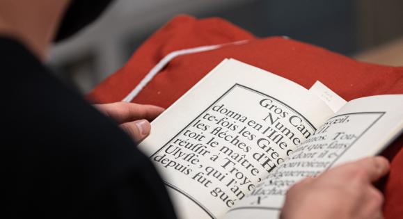 A student reading a book in the library