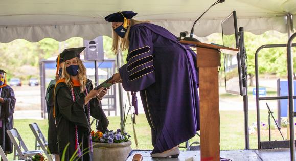 Yale School of Nursing graduate accepting a diploma at commencement