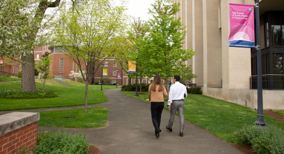 Two students walking outside of the Yale School of Public Health