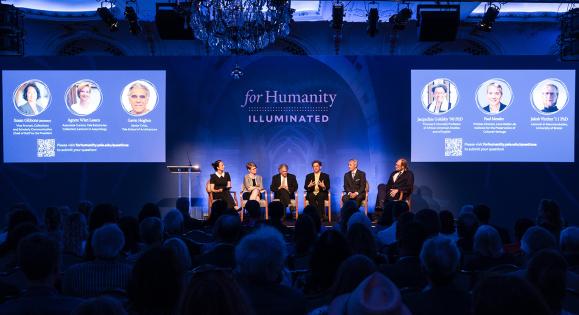 Panelists on stage at For Humanity Illuminated in London