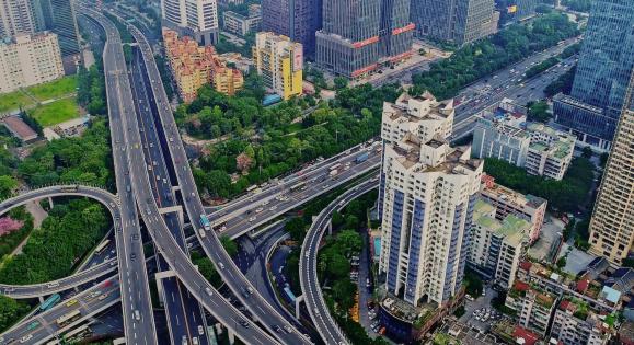 Aerial view of a highway interchange in a densely populated urban area