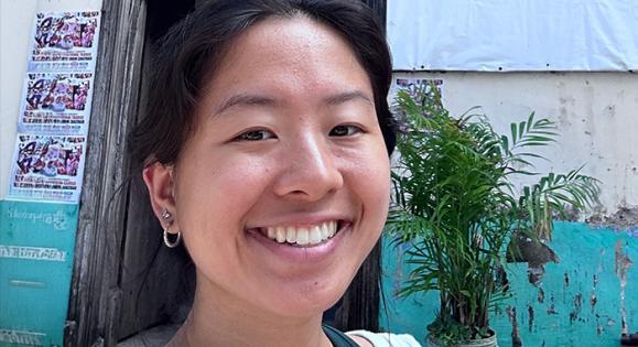 Sheeline Yu ’25 in front the Dhow Countries Music Academy building