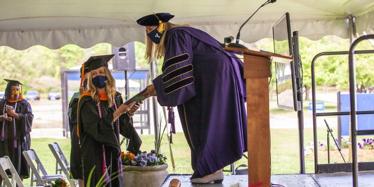 Yale School of Nursing graduate accepting a diploma at commencement