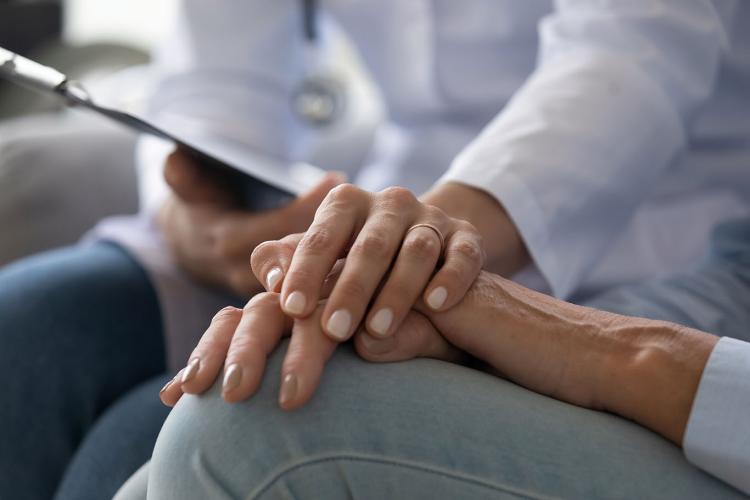 Closeup of a doctor holding a patient's hand