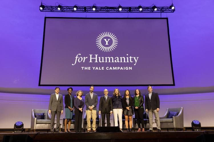 Panelists pose on stage at For Humanity Illuminated in Chicago