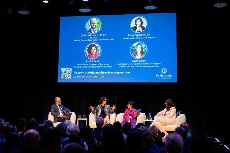 Panelists in conversation on stage at For Humanity Illuminated in Fort Worth