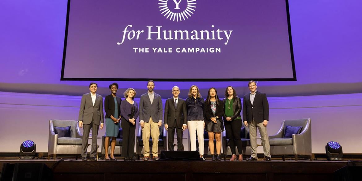 Participants pose on stage at For Humanity Illuminated in Chicago