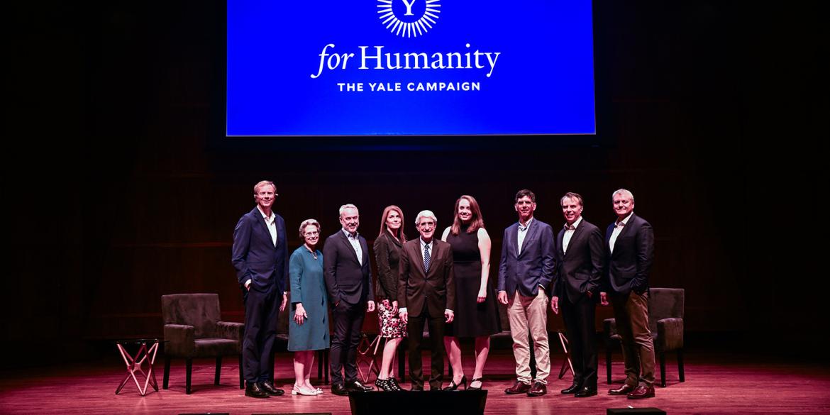 Event speakers pose on stage at For Humanity Illuminated in Seattle