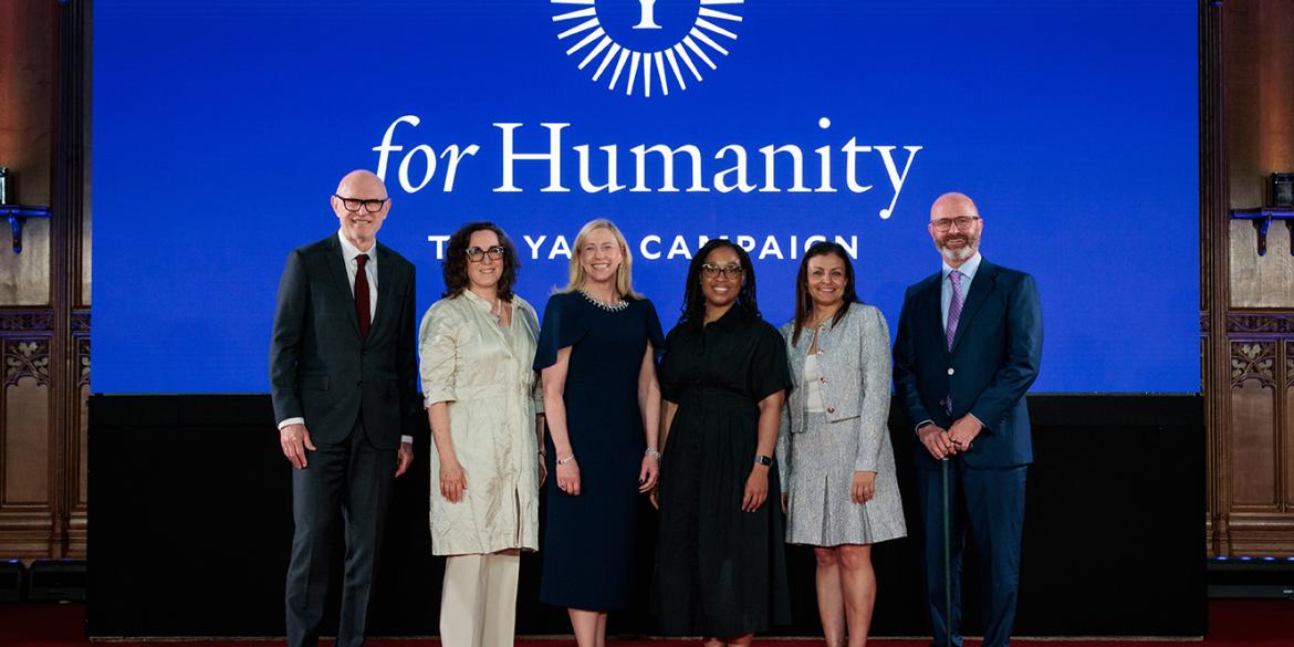 Speakers pose for a photo at For Humanity Illuminated in London