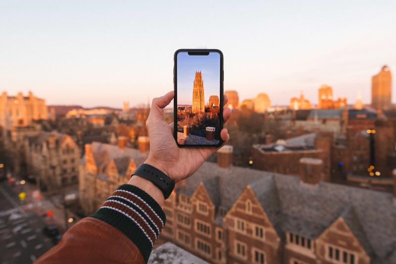 Student taking a photo of Yale campus